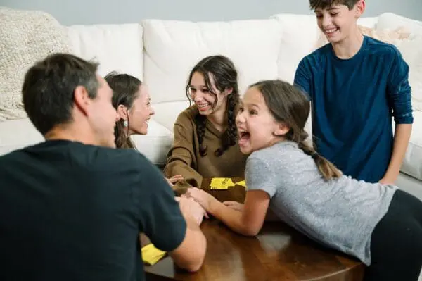 A family having fun playing Taco Cat Goat Cheese Pizza